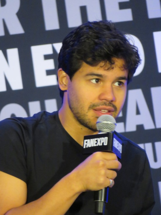 Carlos Valdes holding a mic and answering a question.