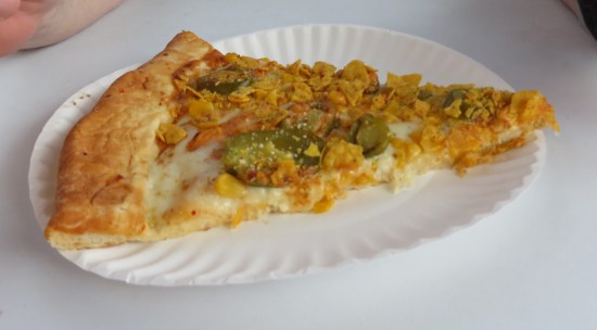 A slice of Elote Pizza, heavy on the jalapenos.
