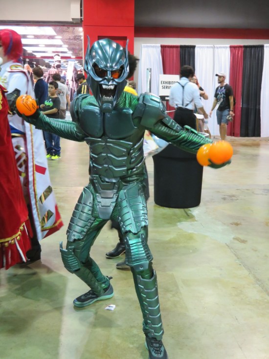 Green Goblin armor from the first Spider-Man movie, holding a pair of orange balloons standing in for his pumpkin bombs.