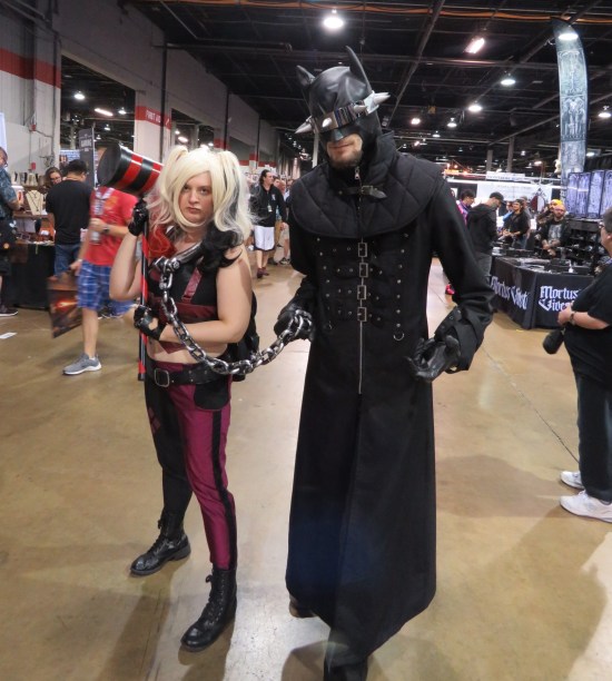 Harley Quinn shackled and dragged on a chain by The Batman Who Laughs.