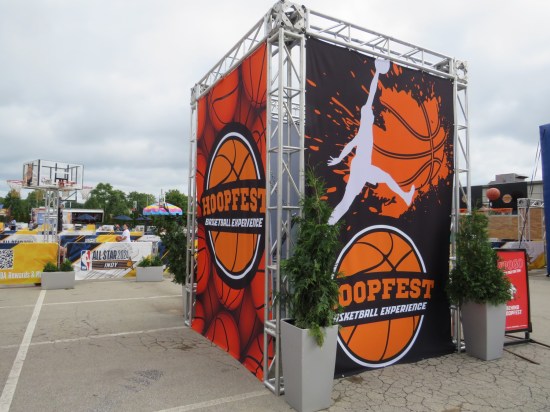 Hoopfest banners around an area containing numerous small basketball courts and nets.