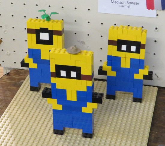 Three 2-dimensional Lego Minions.