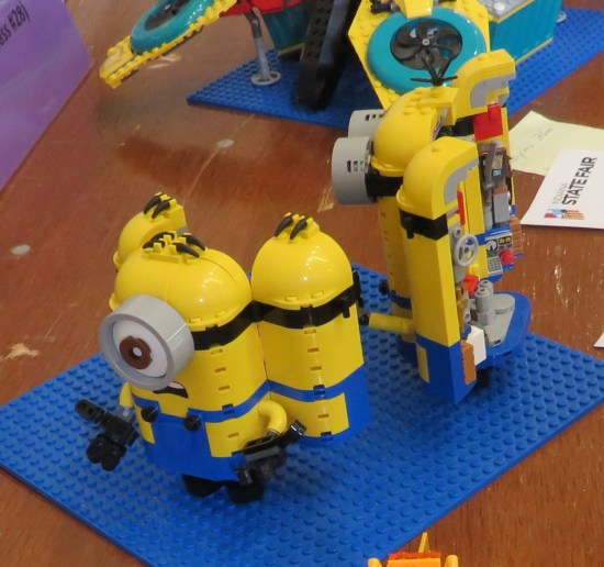 A pair of Lego Minions, each of which open in the back to show off their robot guts.