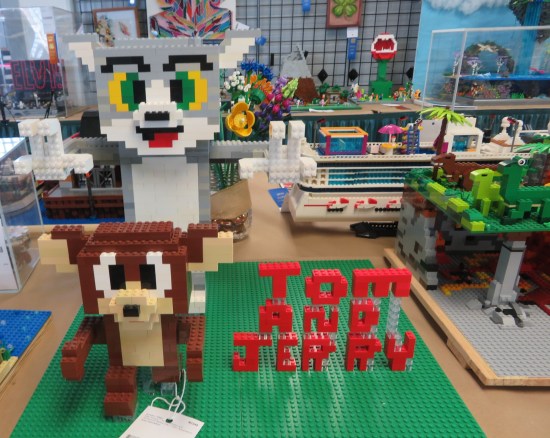 Lego Tom and Jerry standing next to a red Lego "Tom and Jerry" logo.