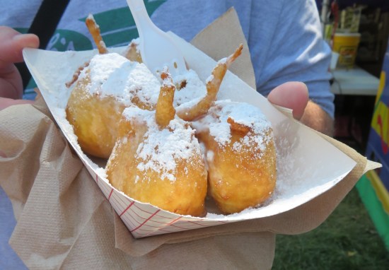 Five deep-fried lemon sponge cake balls drowning in sugar.