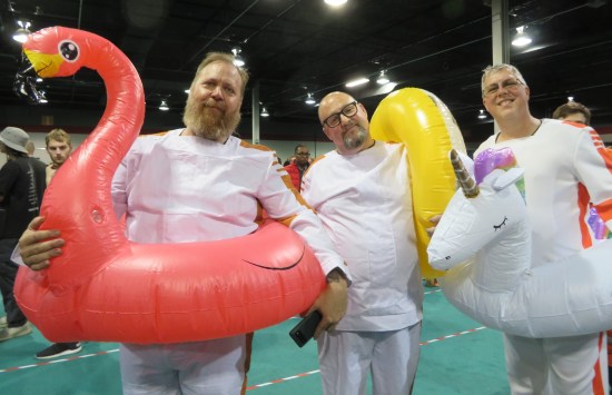 3 gents in Narkina 5 jail costumes, all wearing giant animal innertubes around their waists.