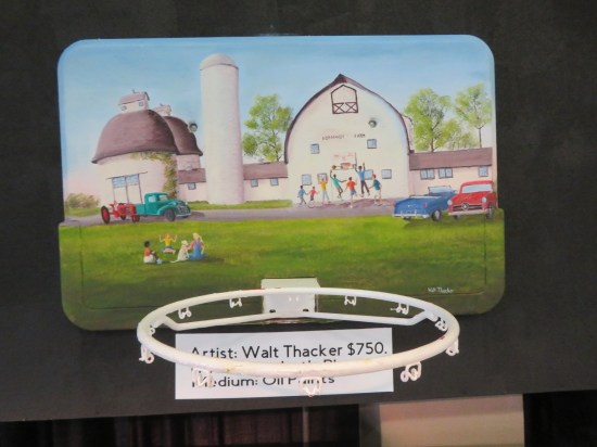 Custom-painted backboard showing kids playing basketball in front of Normandy Farms' white buildings.