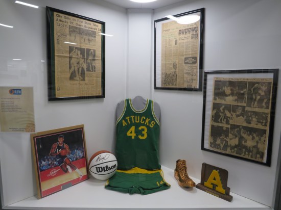 Oscar Robertson artifacts, such as newspaper clippings, an autographed basketball, a golden shoe, and a Crispus Attucks High School jersey #43.