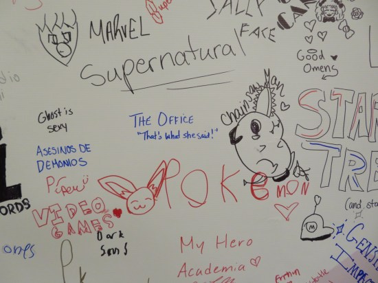 Various handwritten characters and show names. "The Office" is squarely in the middle.