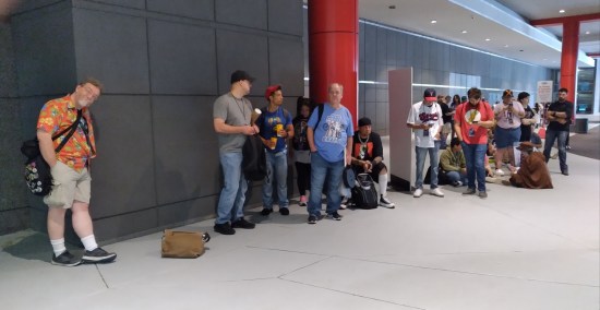 Me leaning against a wall with dozens of fans lined up behind me.