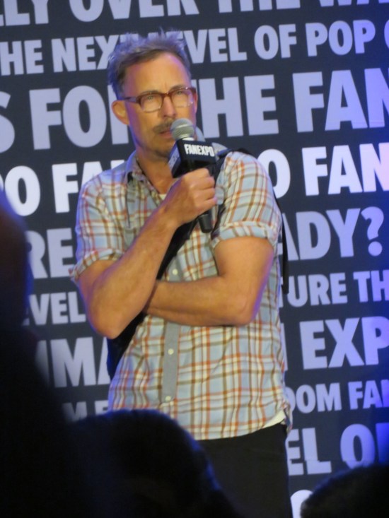 Tom Cavanaugh with a mic, thinking hard.