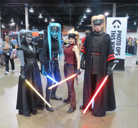 Fourt Twi'leks with robes and lightsabers. One is a Sith, the rest Jedi.