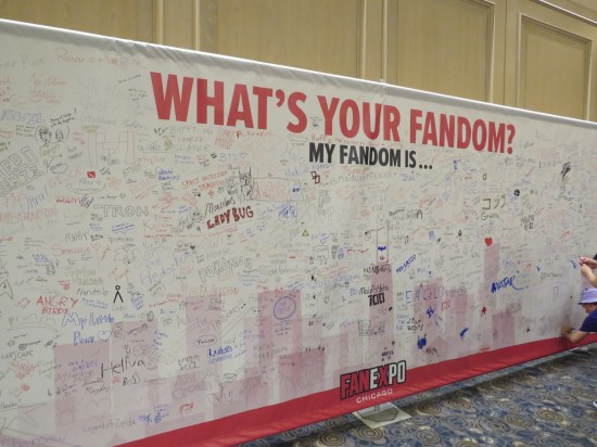 A mural titled "What's Your Fandom?" with the names of hundreds of intellectual properties and universes handwritten all over it.