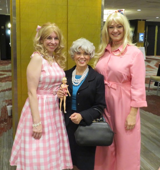 cosplay: Barbie in pink jumpsuit, Barbie in pink farmer's daughter dress, and Ruth Handler as played by Rhea Perlman in the movie.