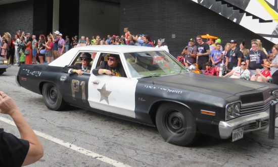 Blues Brothers cosplayers in their stolen police car.