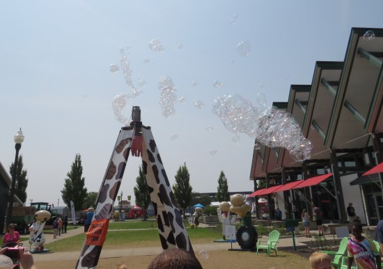 A 7-foot tower dressed in fake cowskin. A bubble machine on top spits out lots of bubbles. At right is the weirdly angular roof of the Glass Barn.