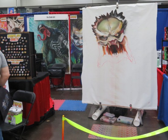 A Predator head drawn in chalk on an art board, with space for plenty more body parts to come.