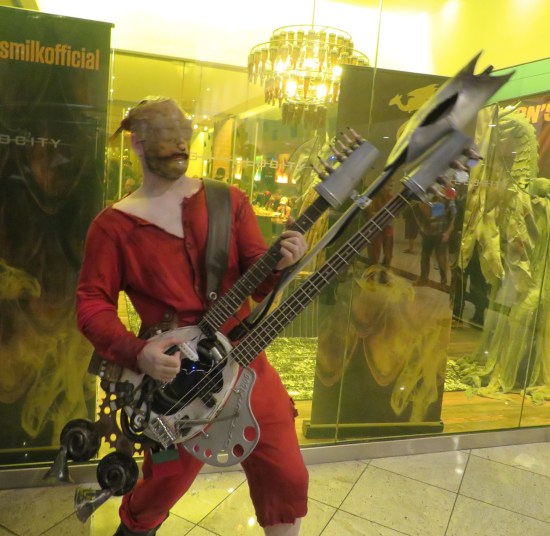 cosplay: Mad Max guy with twin-necked guitar.