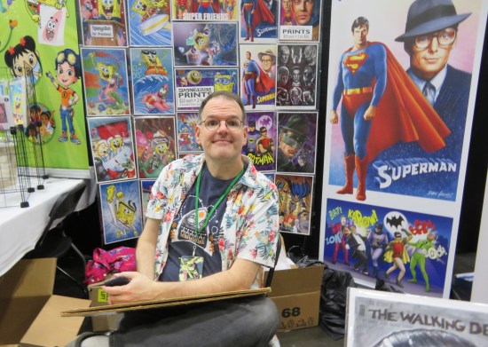 Artist Dave Aikins, whose booth art includes Christoper Reeve's Superman, SpongeBob, and the Green Hornet.