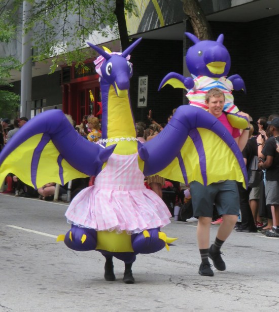 cosplay: Dragon Con inflatable dragon mascot in a gingham Barbie dress, plus a nice guy piggybacking a baby inflatable Dragon Con dragon.