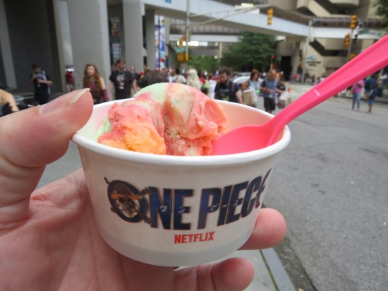 A cup of One Piece ice cream in my hand with pink spoon.