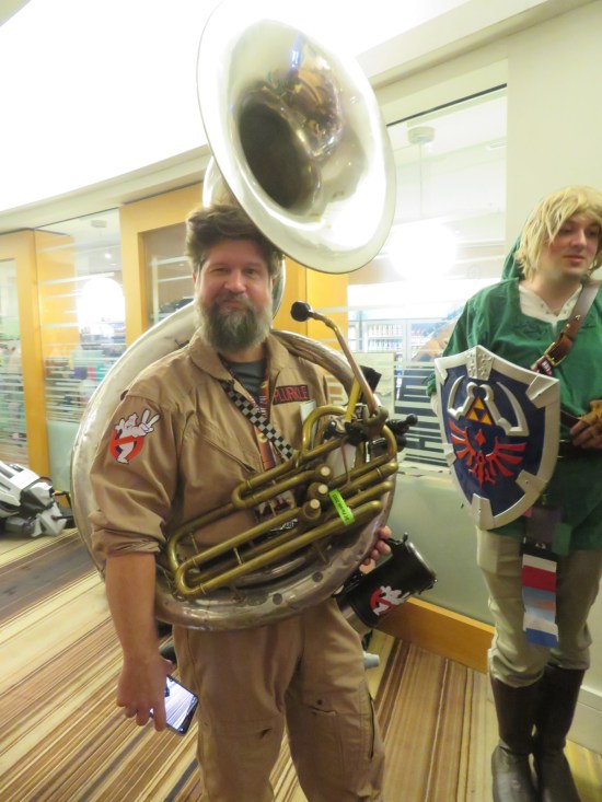 cosplay: Ghostbuster wearing/carrying a sousaphone or tuba or possibly even a helicon.