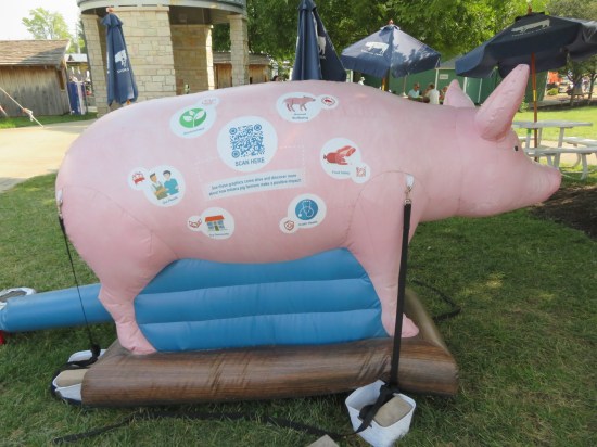 A pig statue covered in educational icons that are explained on the app they want you to download.
