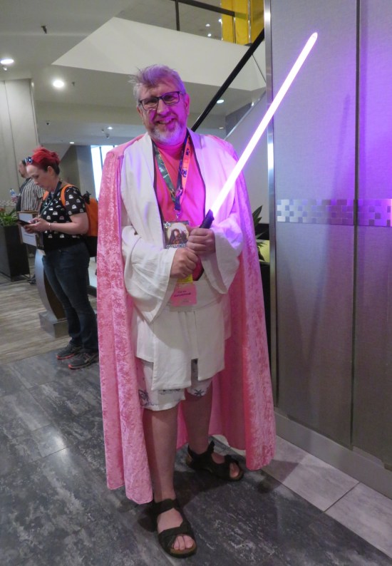 cosplay: Obi-Wan Kenobi but all pink. Not pictured: the back of his cape says "KENobi".