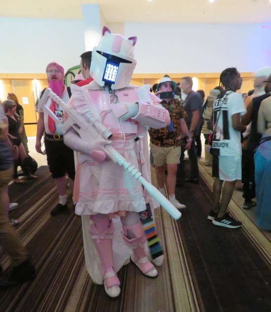 cosplay: pink Mandalorian armor with pink skirt and pink rifle.