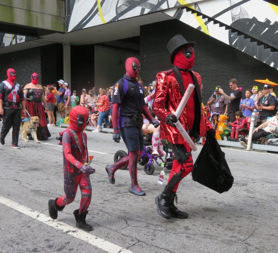 Deadpool kid, Deadpool in Federal Express black and purple uniform, Deadpool stage magician again.