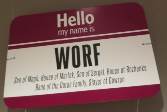 Giant nametag: "Hello, My Name is Worf: Son of Mogh, House of Martok, Son of Sergei, House of Rozhenko, Bane of the Duras Family, Slayer of Gowron:.