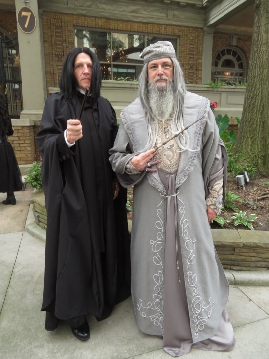 cosplay: Professors Snape and Dumbledore, both wielding wands.