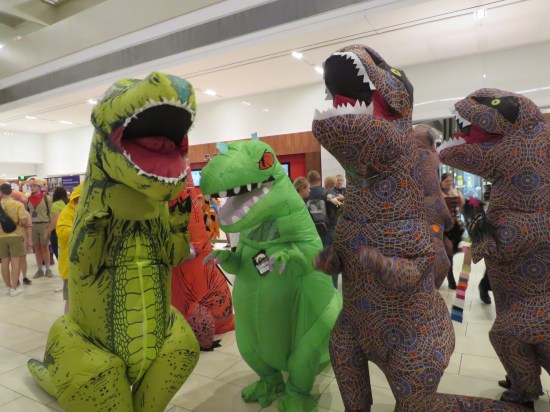 cosplay: four inflatable dinosaurs. 