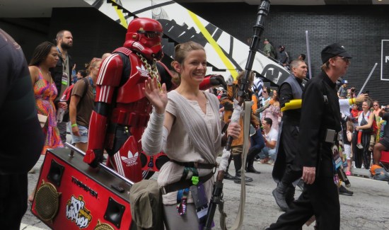 costumes: Rey and a red Stormtrooper with Adidas logos, gold chains and a red boom box.