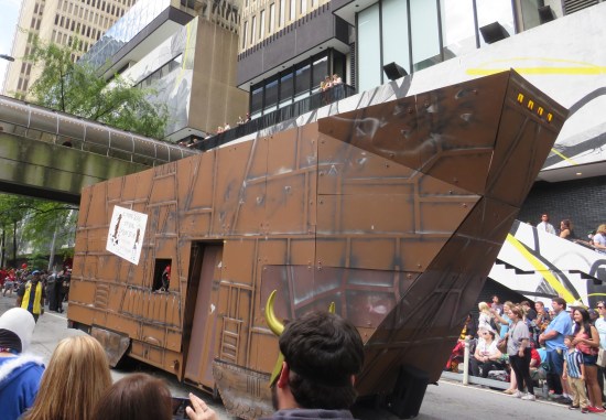 Jawa Sandcrawler, very tall, driving down the street.
