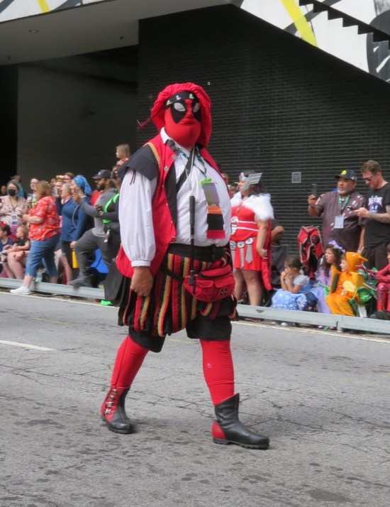 Deadpool with red and black kilt, red beret and vest.