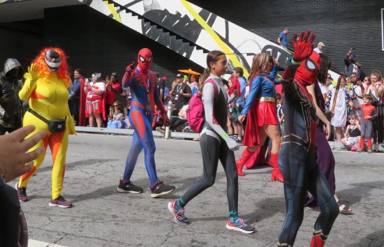 Three Spider-themed cosplayers (one of them Spider-Gwen) and the yellow evil symbiote Scream.