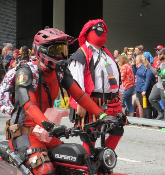 Stuntpool on motorcycle zooms past Scotpool.