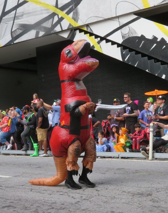 Inflatable T-Rex costume dressed in a Deadpool costume.