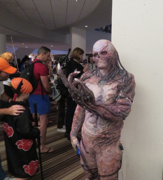 cosplay: Vecna, full body rubber suit, trying to check his phone.