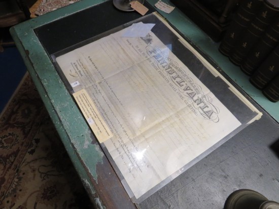 Large 170-year-old document in a desktop vitrine.