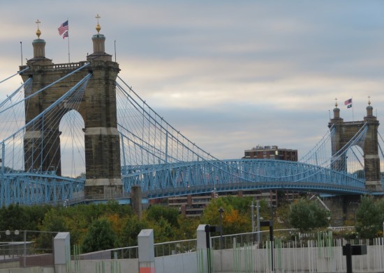 Long suspension bridge over the Ohio River (which is not in the shot) between Ohio and Kentucky. The girders and suspension cables are all weirdly baby blue.
