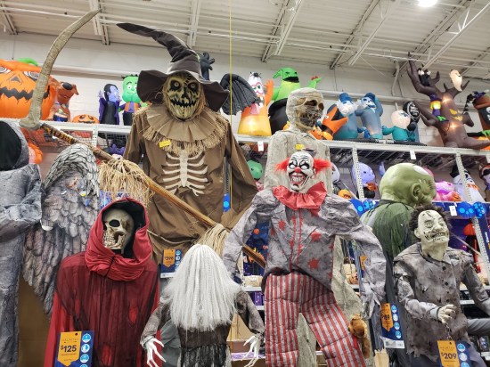 Collection of large Halloween lawn creepy figures, on sale in a hardware store.