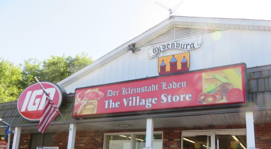 Local IGA grocery sign. called both The Village Store and Der Kleinstadt Laden.