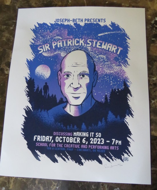 A poster of this event with Patrick Stewart drawn in purple, white and blue against a starry night in a darkened forest with a full moon above. In the bottom-right corner is the logo of one Cricket Press and an inscrutable artist's autograph.