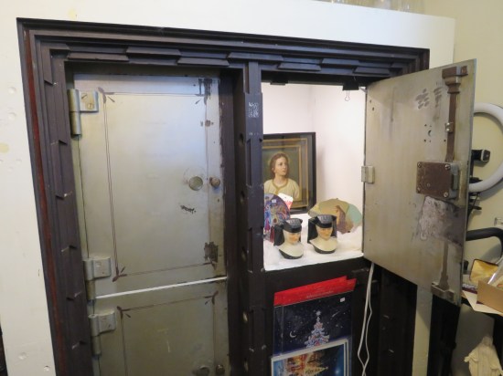 Old Safe deposit boxes now filled with old plates, nun busts, and Christmas decorations.