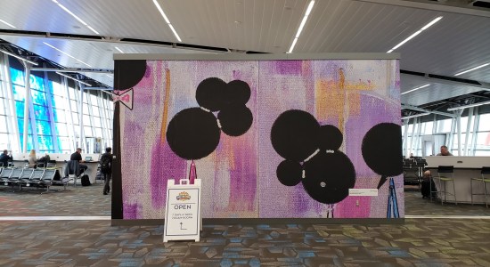 Abstract art tapestry, white and purple with big black dots.