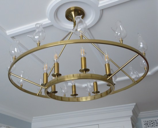 Round chandelier. Every light bulb is shaped like a tiny happy bird.