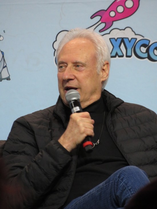 A chatty Brent Spiner sitting with mic.