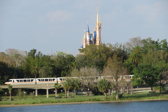 Cinderella Castle at Disney's Magic Kingdom, rising above the trees on the water's edge.